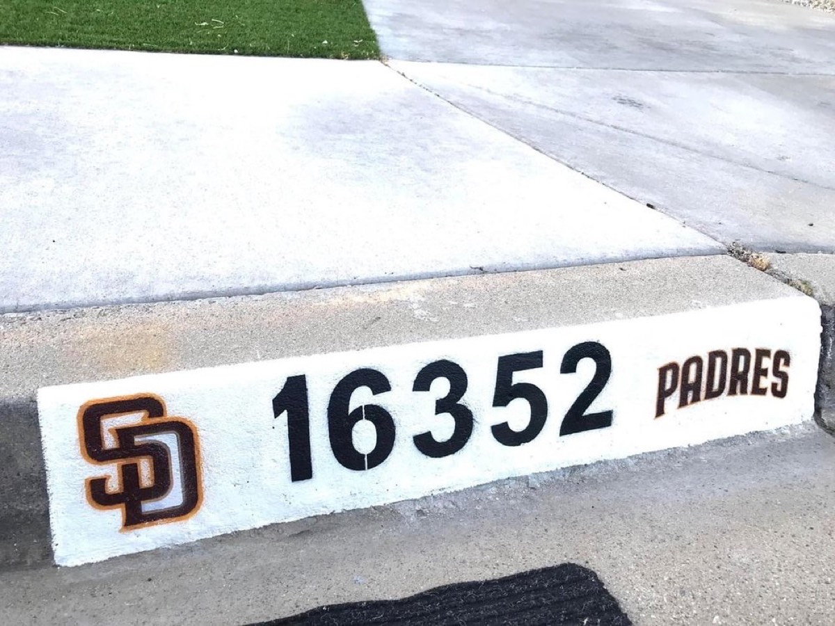 Custom painted curb address number with a San Diego Padres logo, done by Curbside Works